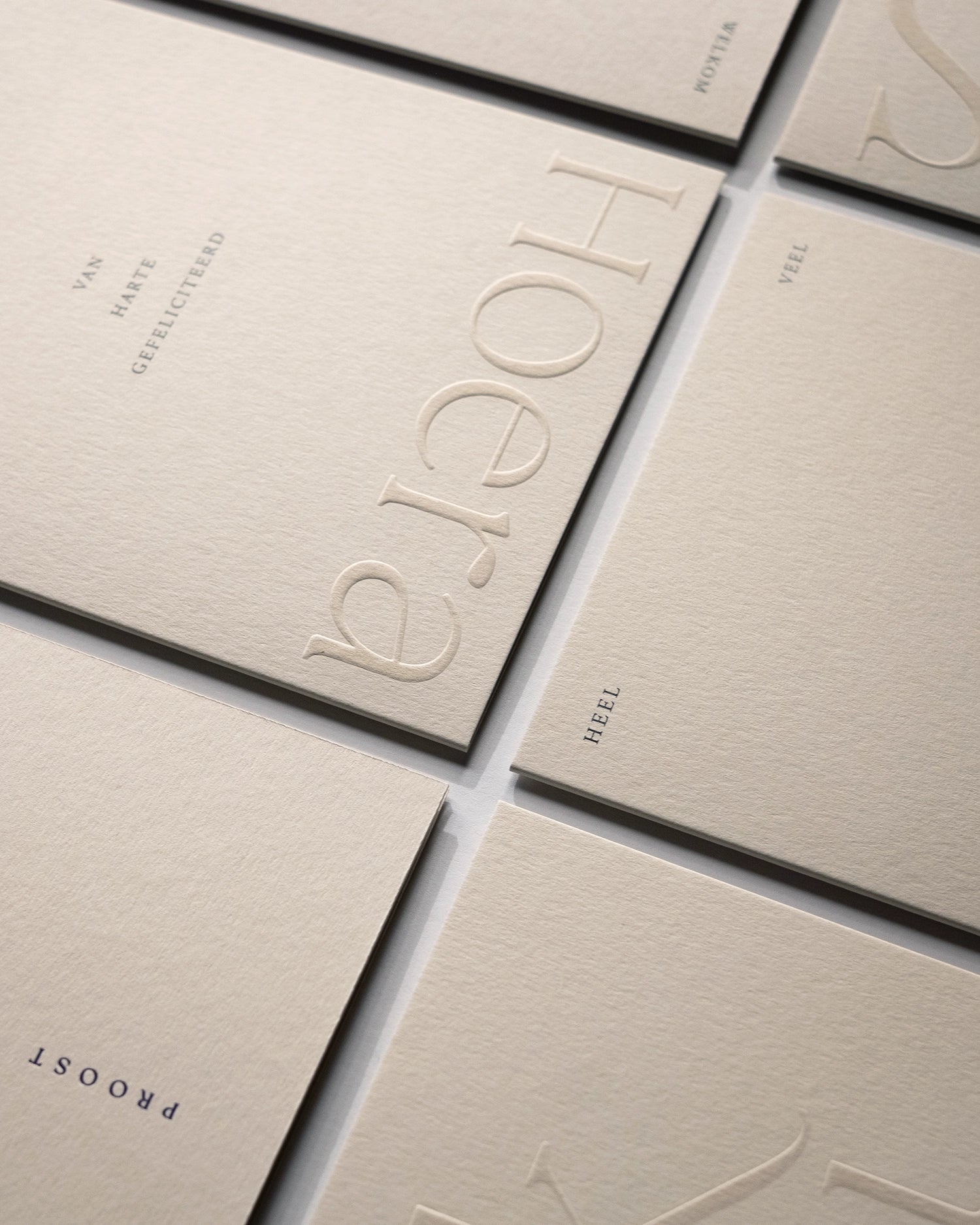 Close-up of minimal luxury embossed greeting cards the complete collection on Colorplan Mist paper