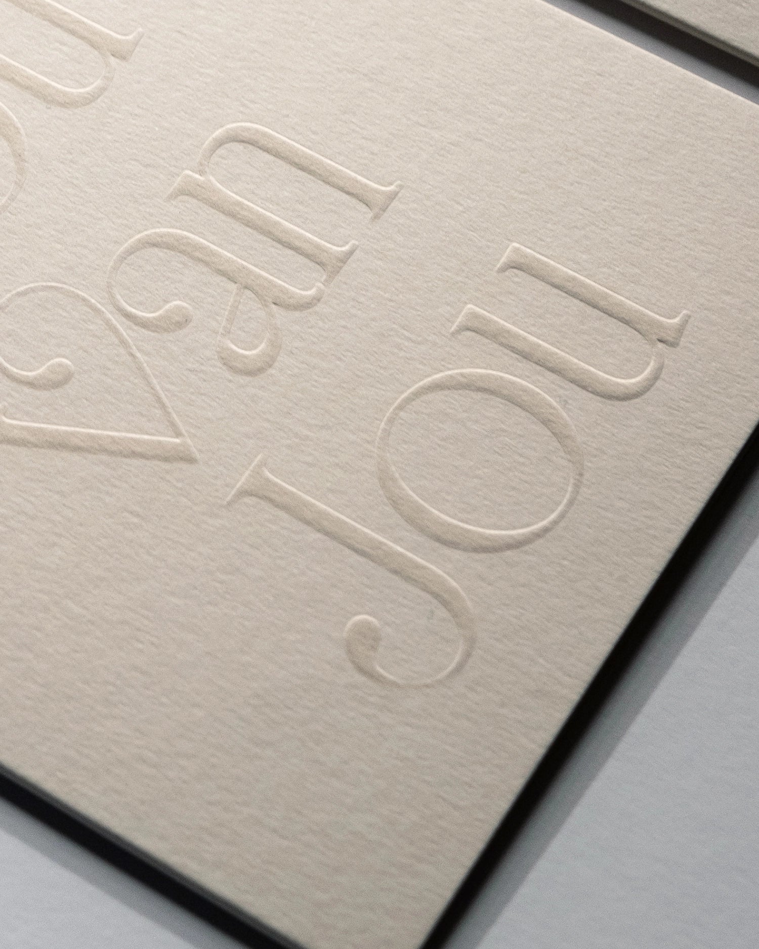 Close-up of minimal luxury embossed love card “ik hou van jou” on Colorplan Mist paper