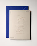 Top view of minimal luxury embossed new baby card “welkom lieve kleine baby” on Colorplan Mist paper with royal blue envelope
