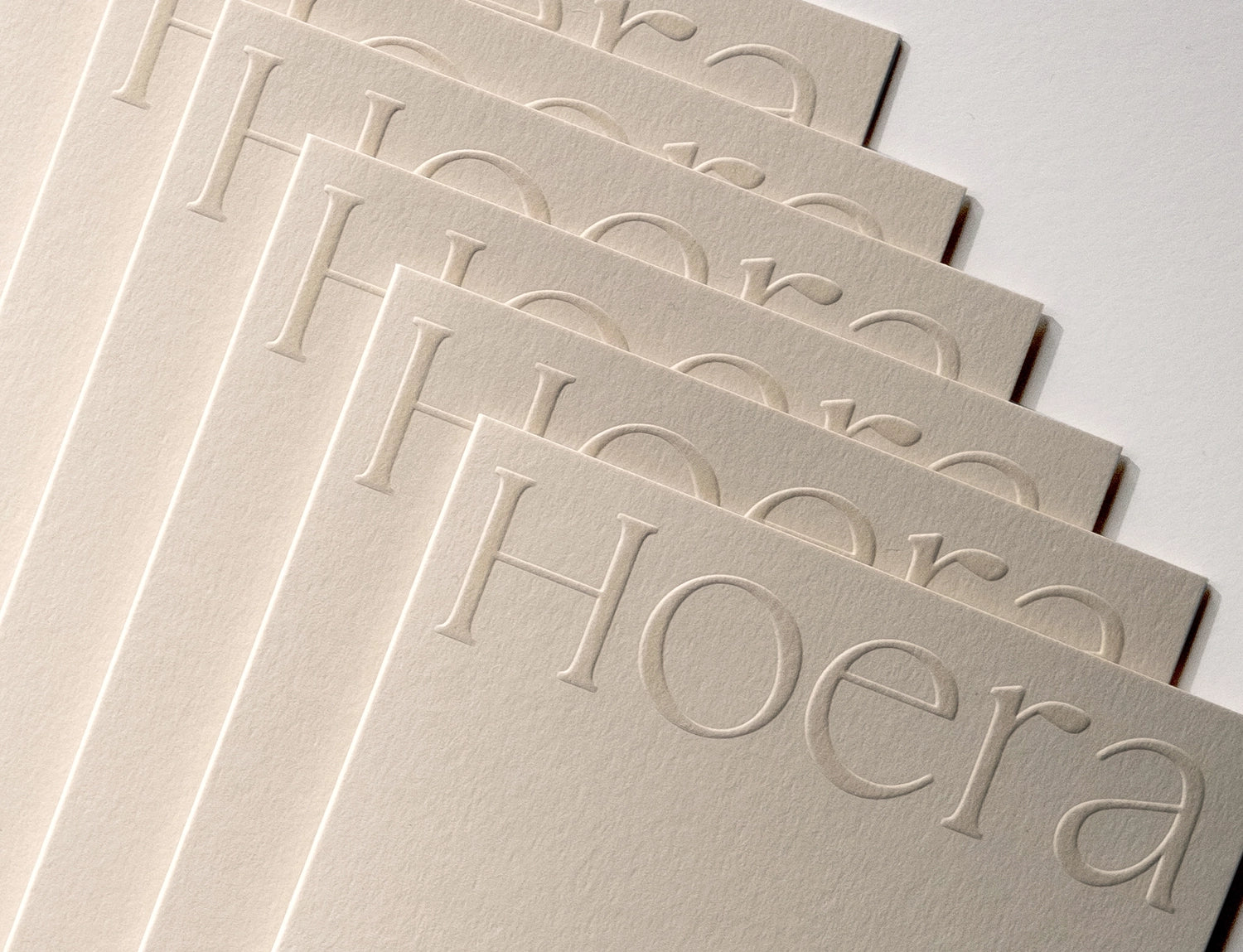 Stacked minimal luxury greeting cards showing embossed detail on Colorplan Mist paper